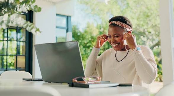 Woman smiling at laptop — templates are the secret weapon of productive creators